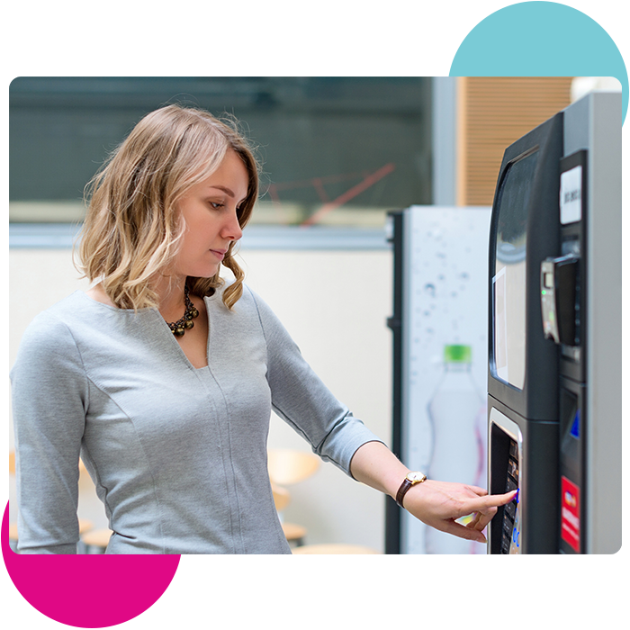 Woman Buying Coffee From Automatic Vending Machine